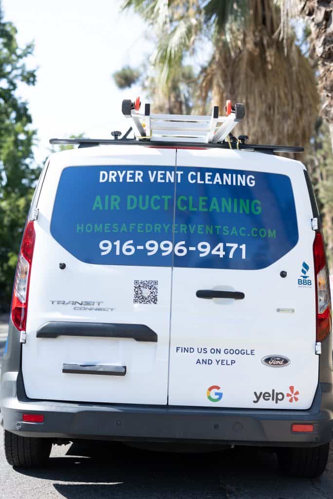 The back of a white van features text and logos advertising services for dryer vent cleaning and air duct cleaning. It includes a phone number (916-584-9367) and website (homesafedryerventsac.com), promoting professional ventilation system cleaning. Logos for Google and Yelp are also displayed.